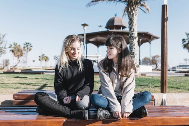 Two friends having a serious conversation on a park bench. One friend is listening intently, with a supportive expression, while the other is speaking with a slightly concerned look. The image focuses on empathy and understanding.