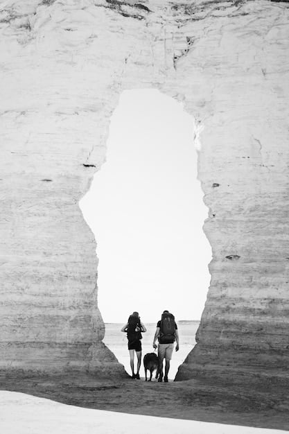 Two friends sitting back-to-back, looking in opposite directions, with a visible crack forming on the ground between them. The crack symbolizes a fracture in their friendship due to betrayal.