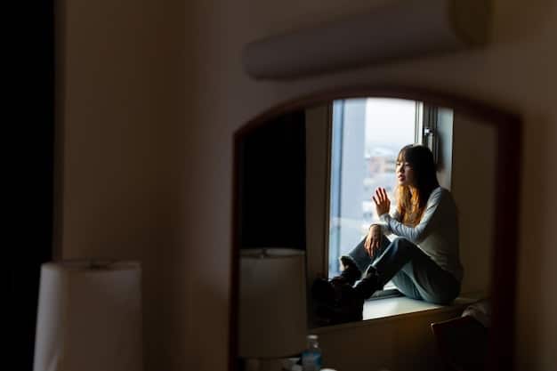 A person sitting alone in a dimly lit room, looking thoughtful and sad, representing the process of acknowledging and processing emotions after a friendship breakup.