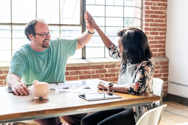 Two friends high-fiving each other after finishing a collaborative project, showing a sense of teamwork and mutual accomplishment.
