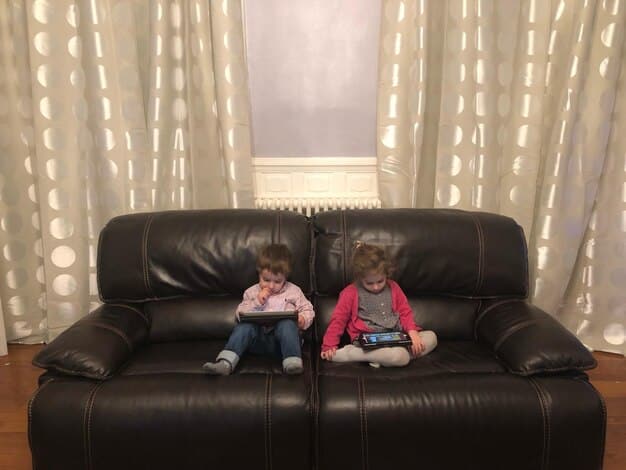 A quiet living room with soft lighting, two comfortable armchairs facing each other. A small coffee table sits between them, with a steaming cup of tea on each side. The scene suggests a calm and intimate setting, conducive to a deep and meaningful conversation.