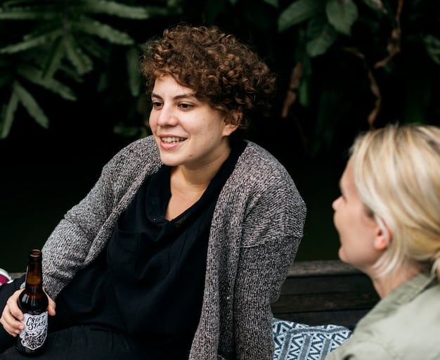 Two friends having a deep and meaningful conversation while sitting on a park bench. They are looking at each other with attentive expressions, showing trust and understanding.
