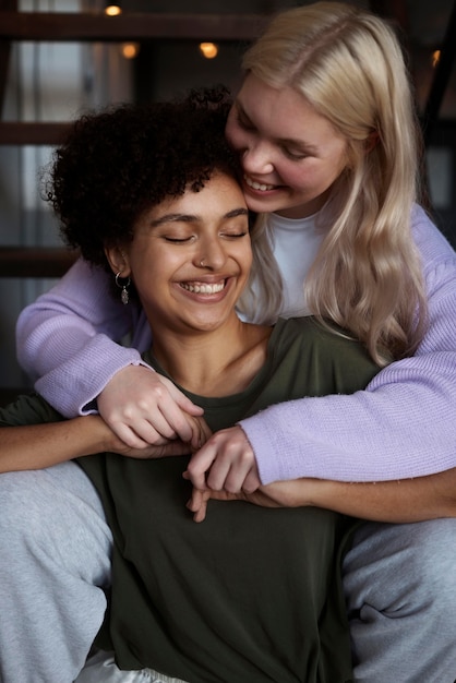 Two friends hugging each other in a supportive and comforting manner. They are in a quiet and private setting, showing a deep emotional connection.