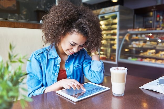 A person confidently updating their LinkedIn profile on a tablet while sitting in a coffee shop. The background shows other professionals working and networking.