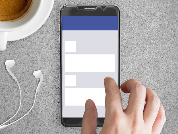 A close-up of a smartphone displaying an email notification with the sender's name and a short preview of the message. The phone is held in a manicured hand, suggesting a professional setting.