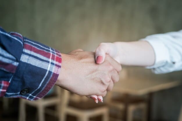 A close-up photo of two hands shaking after a discussion, symbolizing conflict resolution and the ability to turn negative interactions into positive relationships.