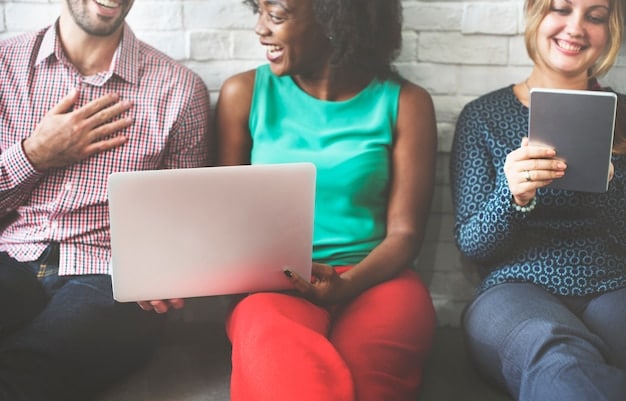 A diverse group of community members actively typing on keyboards and discussing ideas around a table, with a shared screen displaying a vibrant online forum. The scene should convey collaboration and shared interest.