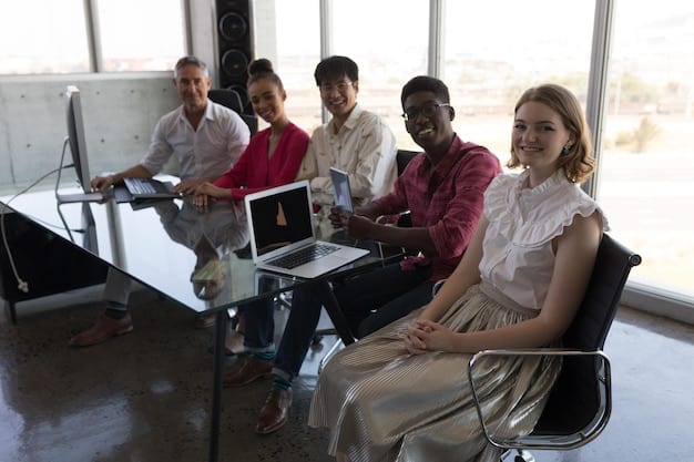A diverse group of employees participating in an interactive diversity and inclusion training session, with a facilitator guiding a discussion. They are engaged and appear to be learning from each other.