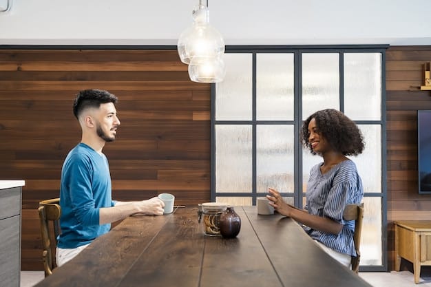 Two people from different cultural backgrounds having a clear, open conversation across a table in an office setting, with subtle gestures indicating understanding and directness.