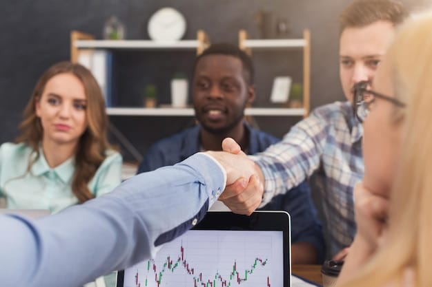 A close-up shot of hands shaking enthusiastically over a financial graph, with diverse faces blurred in the background, symbolizing successful collaboration and investment in a dynamic business setting.