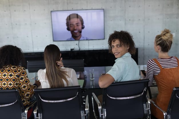 A diverse group of employees engaged in a training session, looking at screens with various accessibility features, symbolizing a company-wide commitment to inclusive practices.