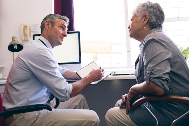 A healthcare professional is speaking clearly and directly to an elderly patient who is wearing hearing aids, while also demonstrating a medical procedure using a visual aid. The interaction emphasizes slow, deliberate communication and visual support.